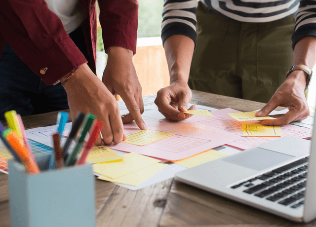 People taking notes in a meeting